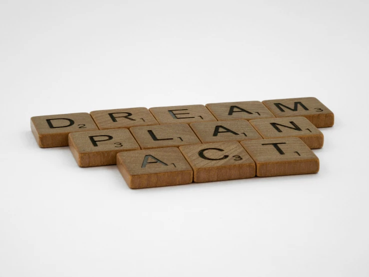 there are three scrabbles that say dream plan act