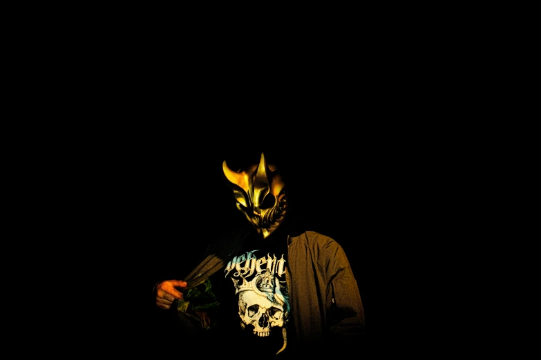 a masked man holding an object in his hands