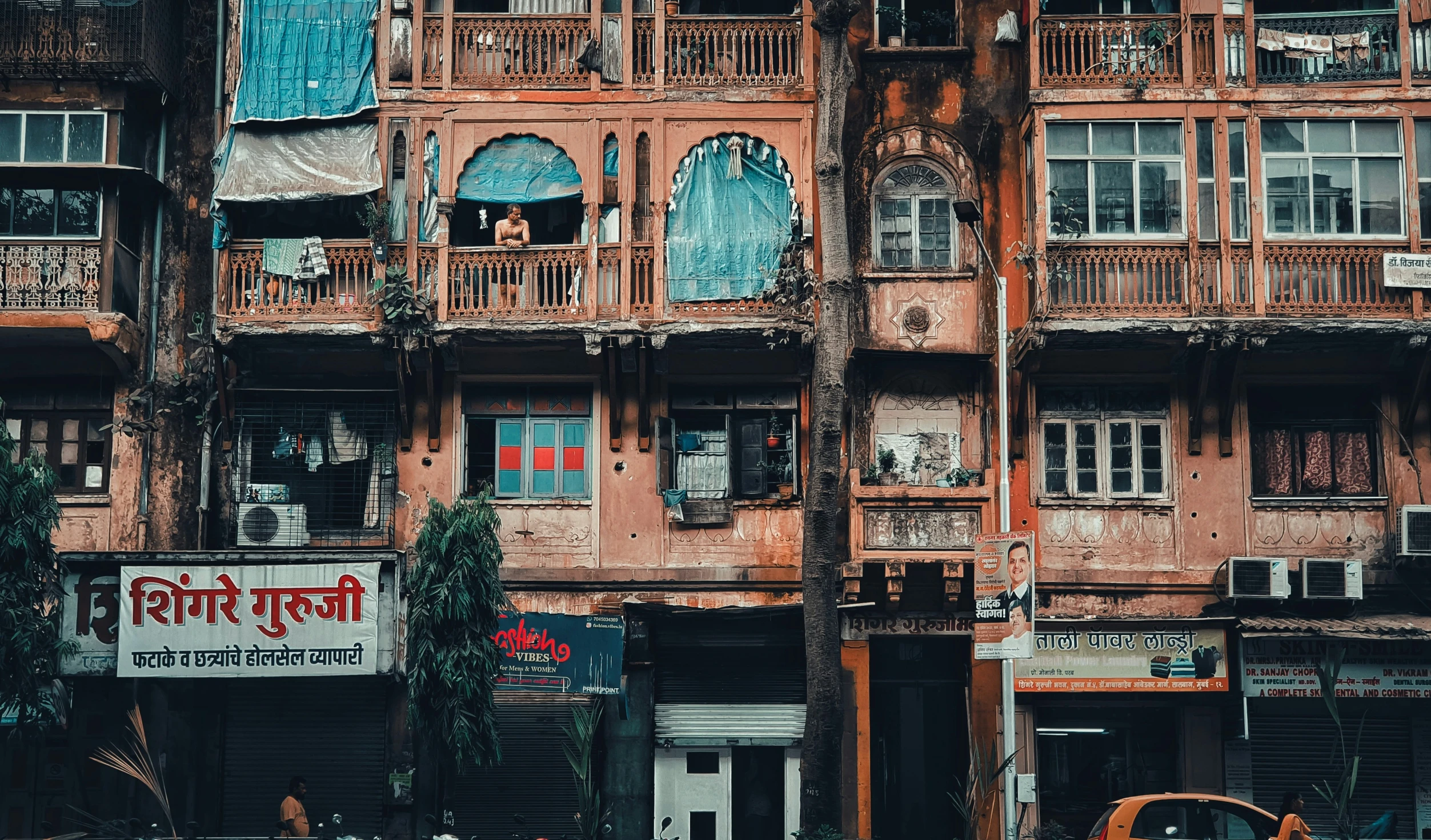 old and dirty run down building with balconies in front