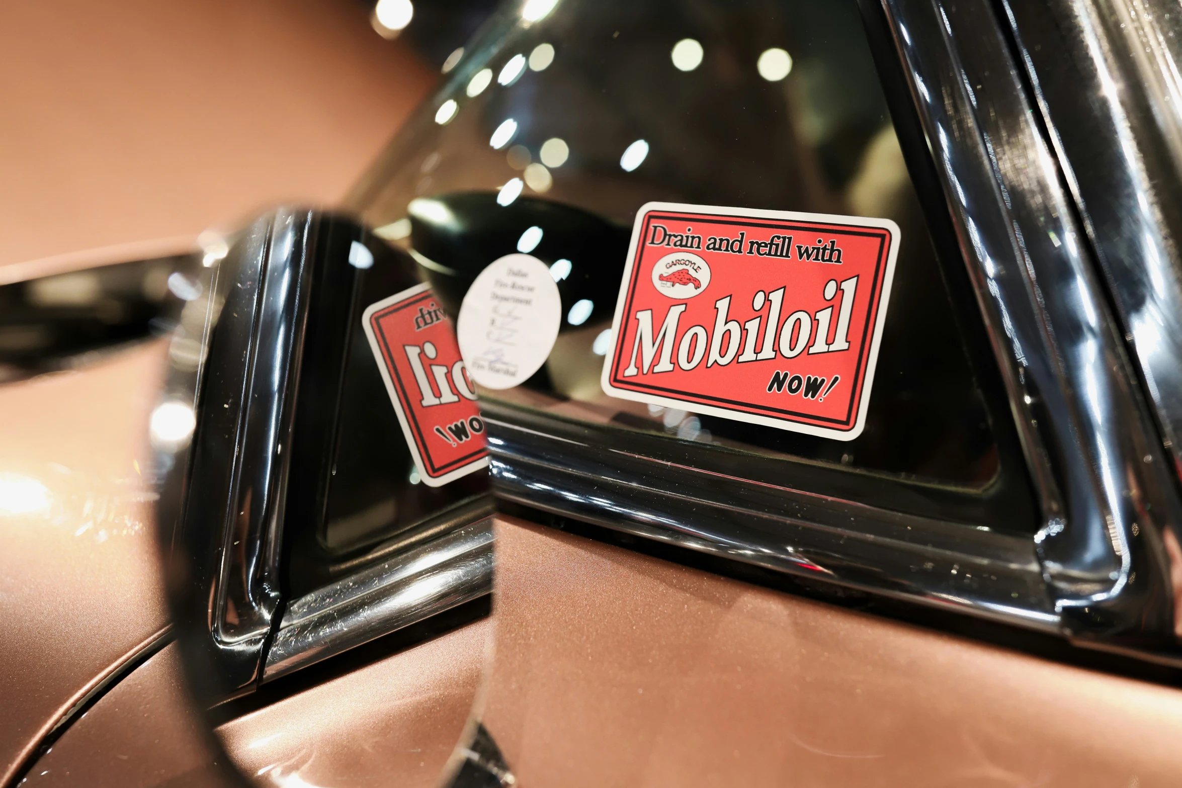 a car with stickers showing the logo for motor oil