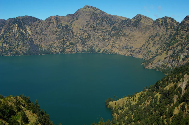 large body of water surrounded by mountain sides