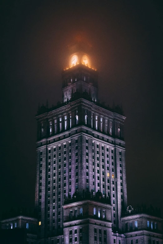 the night lights are on in front of an old stone building