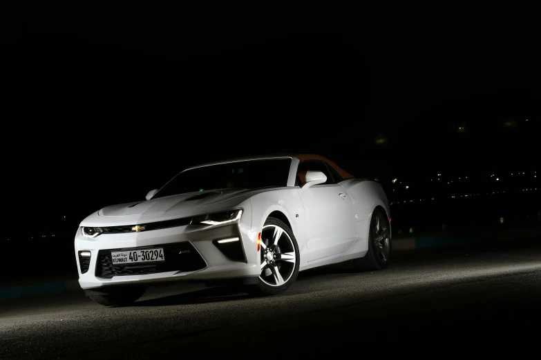 a very cute white convertible car on the street