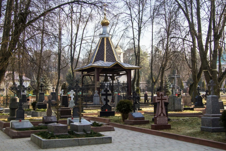 an old cemetery is surrounded by old graves and trees