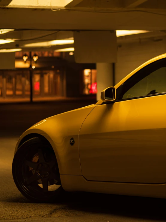 a yellow car parked inside a parking garage
