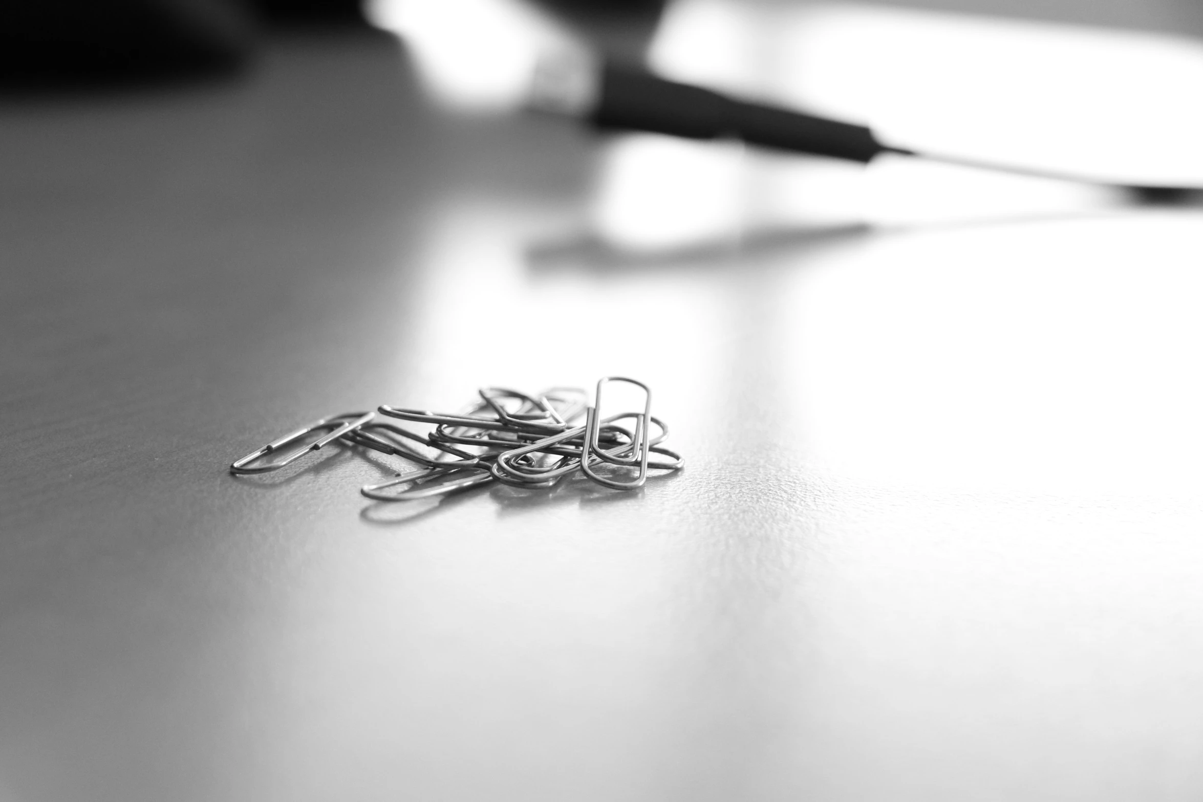 a group of silver scissors and two white ones