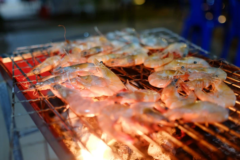 some shrimp are cooking on a grill