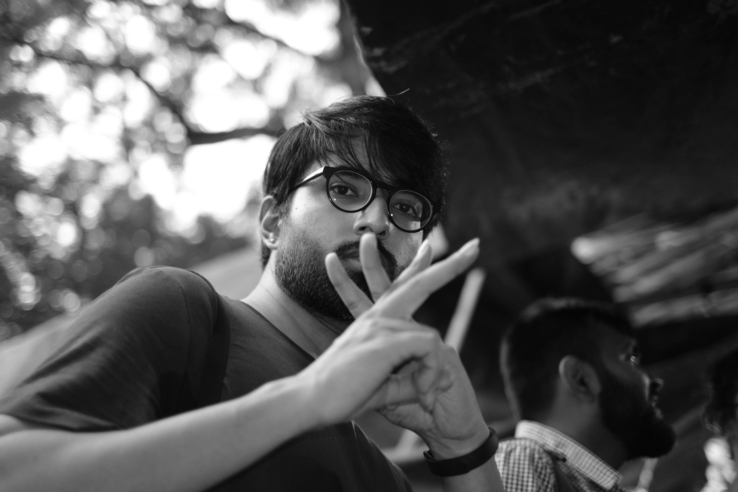 a young man smoking a cigarette and looking sideways