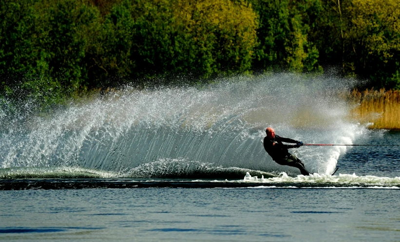 a person in the air skis and water splashing