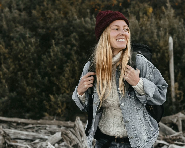 a smiling young woman holding her hands on her chest