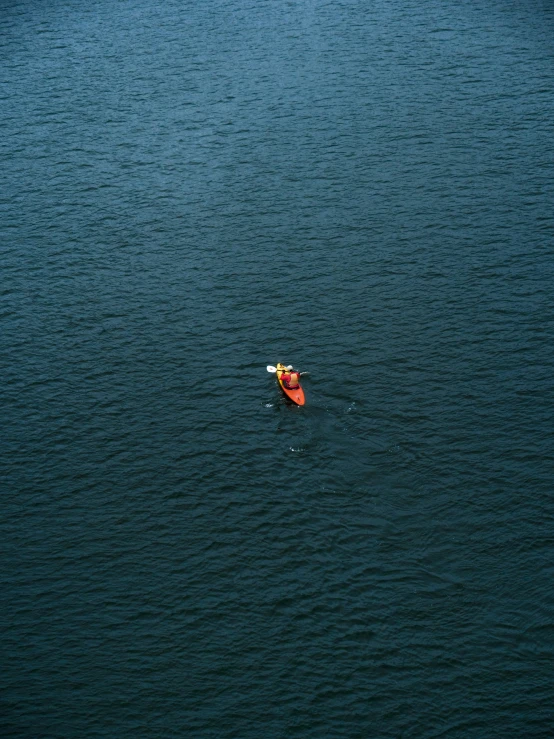 there is a orange buoy in the middle of the water