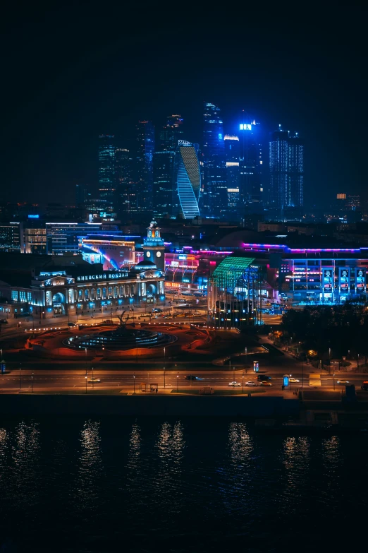 city lights reflecting off the water at night