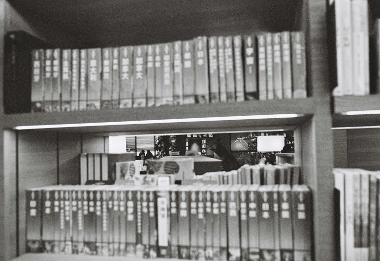 several rows of books in a room full of books