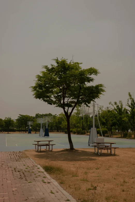 an empty park bench next to a lake