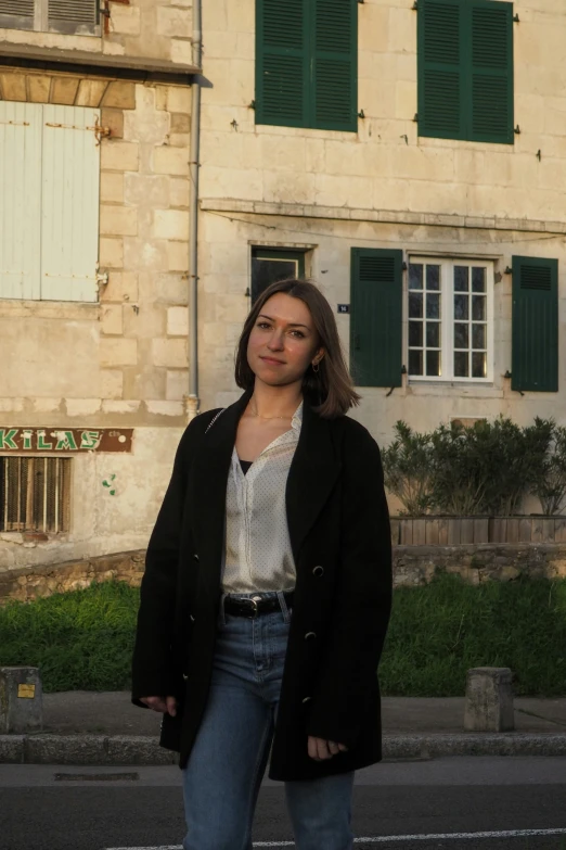 a woman is posing on the street for a po