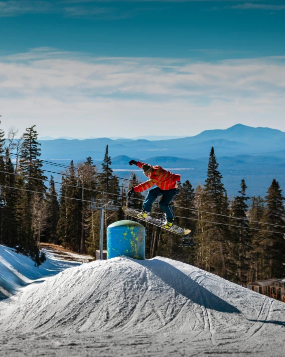 a man that is in the air on a snowboard