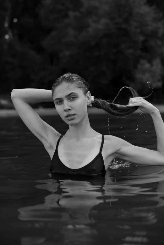 a woman in the water wearing a bathing suit