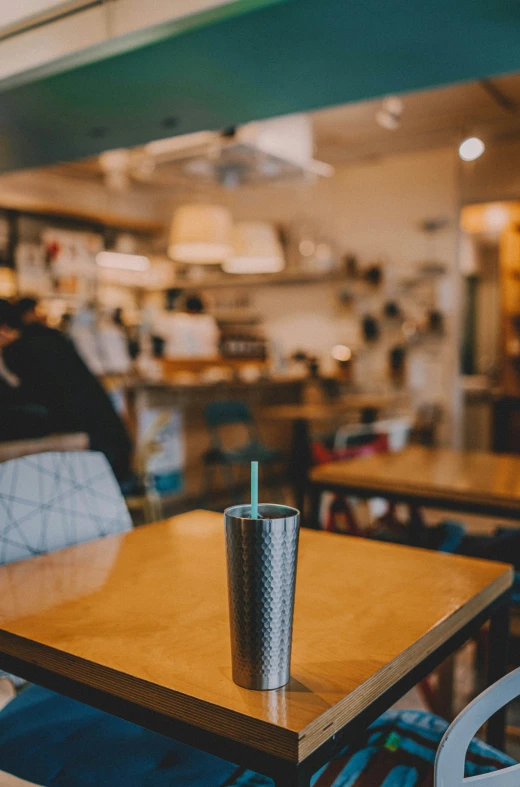 a take out food and drink is on a table in a cafe