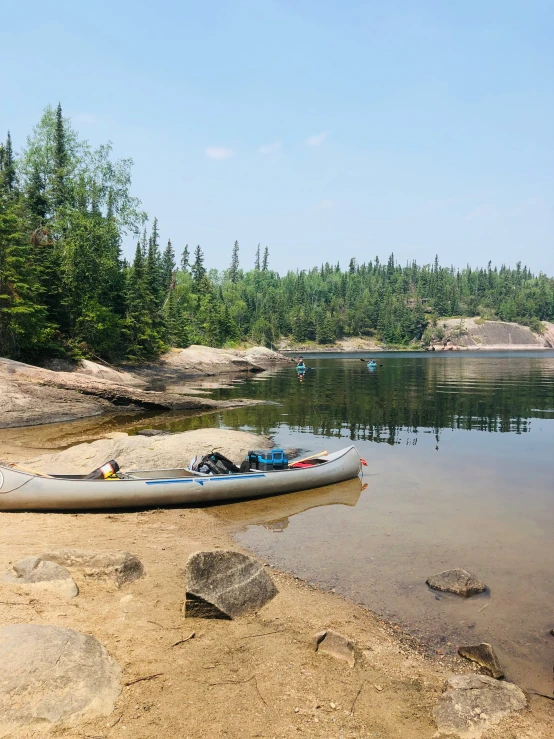 there is a kayak on the shore of the water