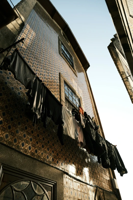 clothes are hanging outside an old brick building