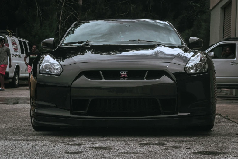 the front of a black sports car with its hood down