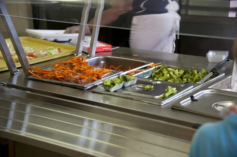 two trays of food sitting on top of a counter