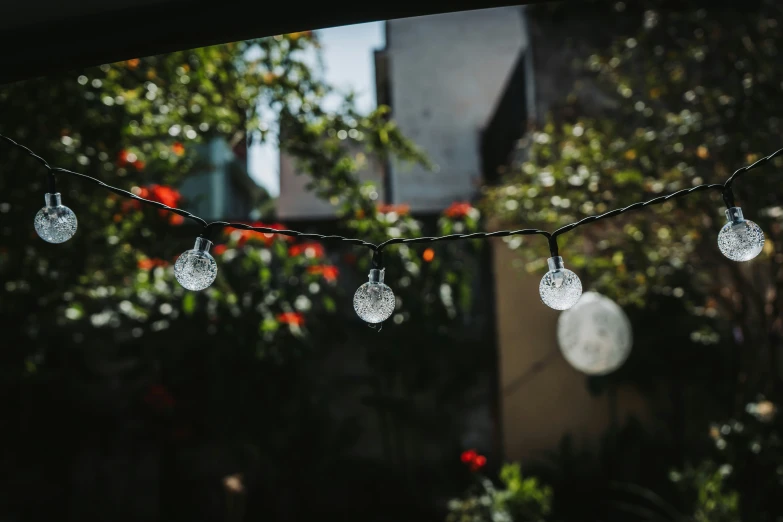 lights strung from a line across a house outside