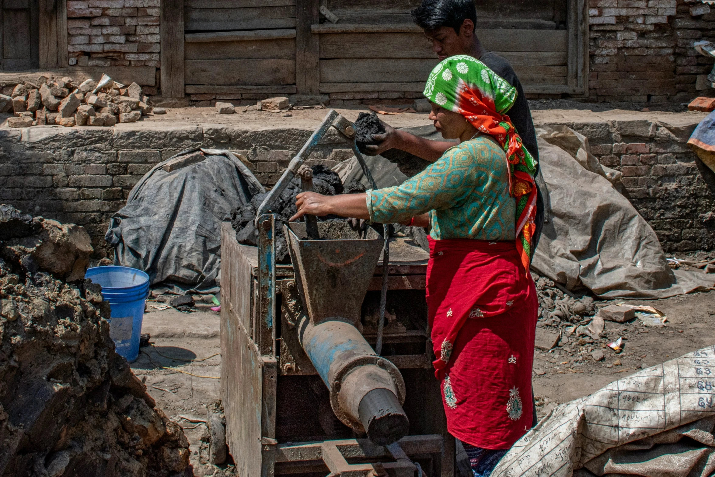 a woman operates a circular steel tool