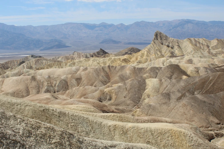 a barren landscape with mountains in the background