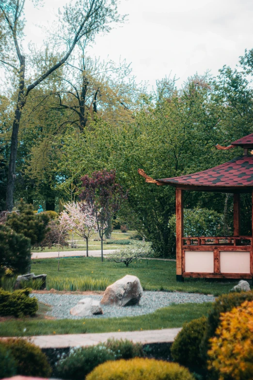 a beautiful view of a park with a gazebo and landscaping