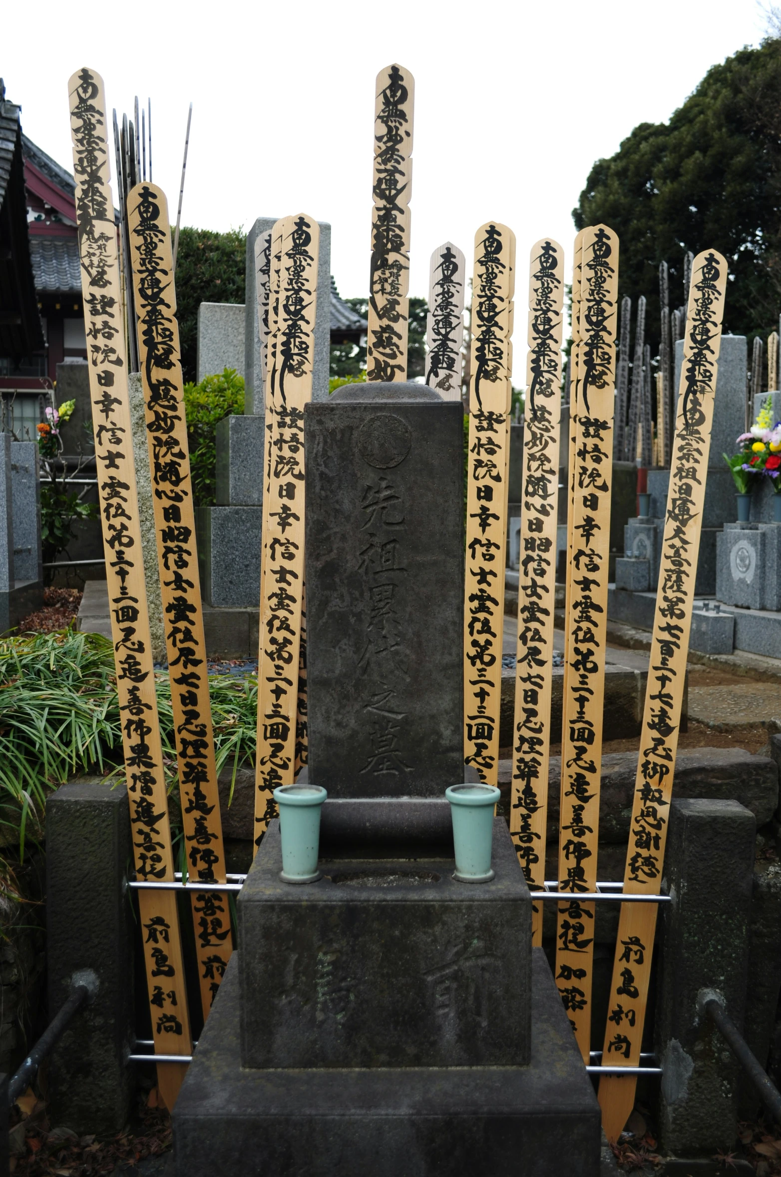 a number of candles with writing on them near a statue