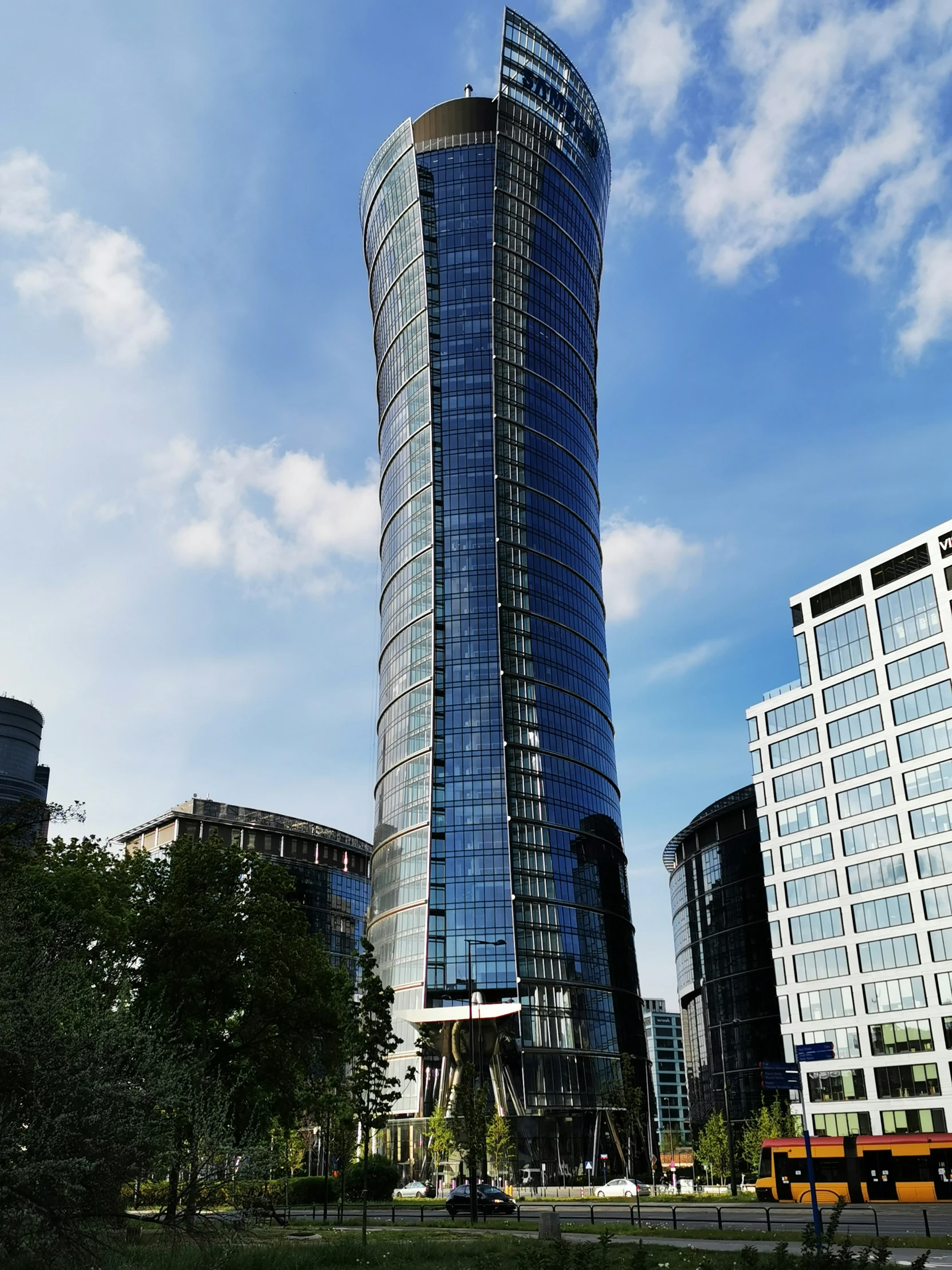 a large round glass building in a city