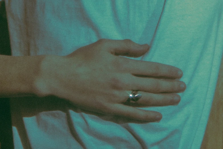 a person with a diamond ring standing by themselves