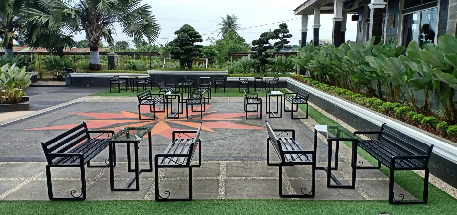 a park with benches, tables and grass