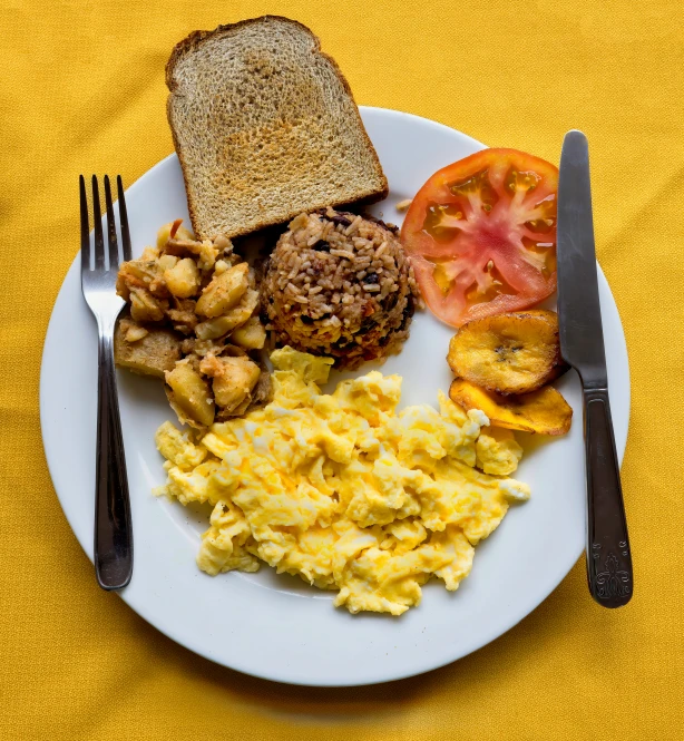 plate of food sitting on table, fork and knife