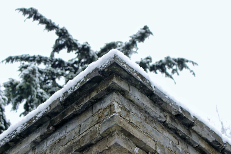 an old house roof covered in snow