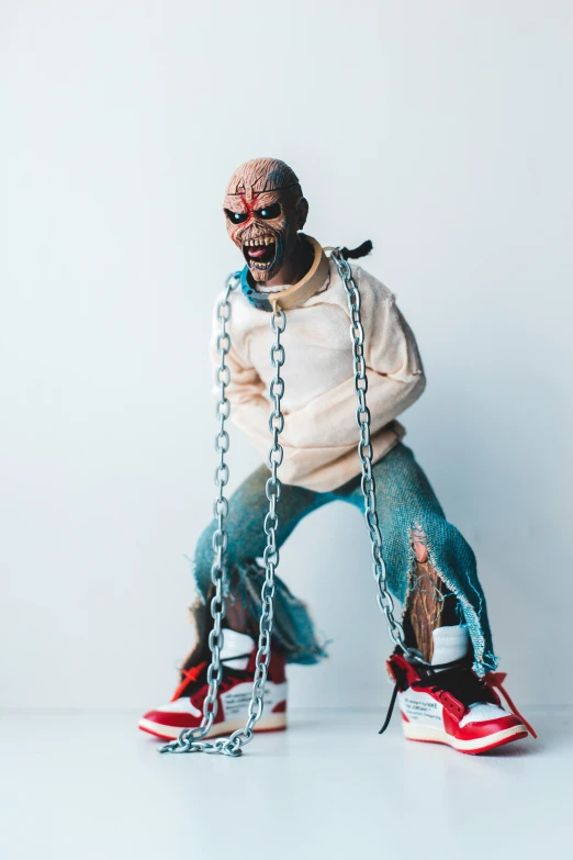 man dressed in old school clothes,  up in chains