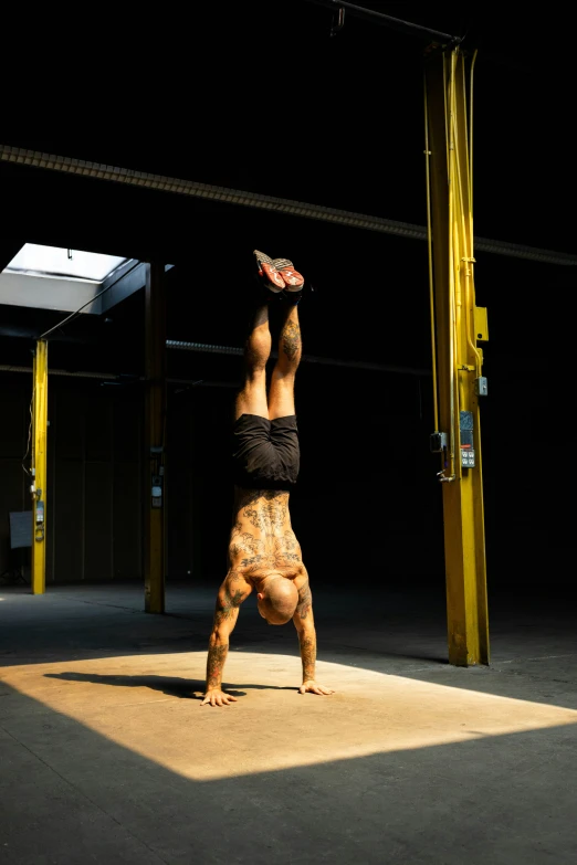 a man doing a handstand with  on