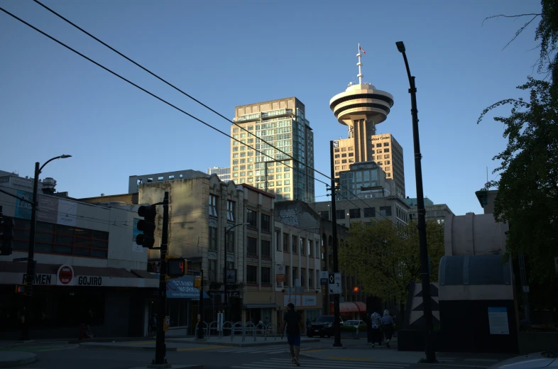 two tall buildings in the background and one very tall building behind them