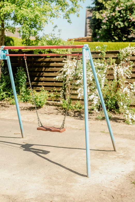 a blue swing set with a wooden swingset