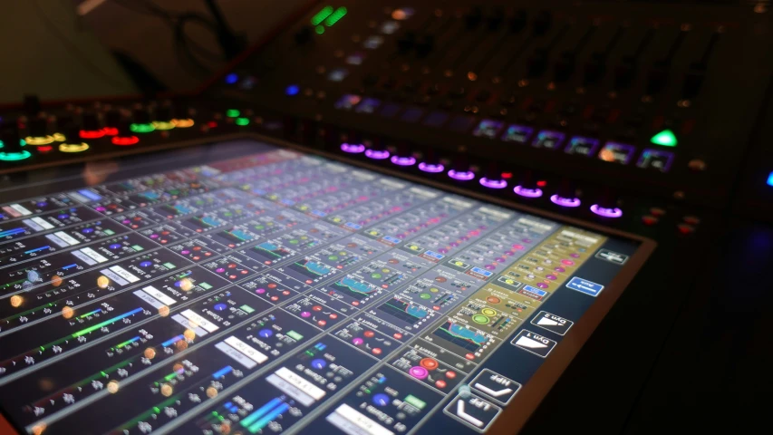 sound board in the dark with lots of colored lights