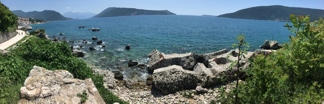 a rocky beach with several boats on it