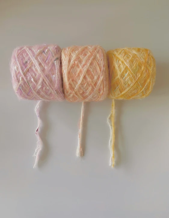 four skeins of yarn on a white background