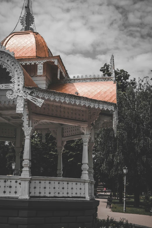 a gazebo has a clock on the side of it