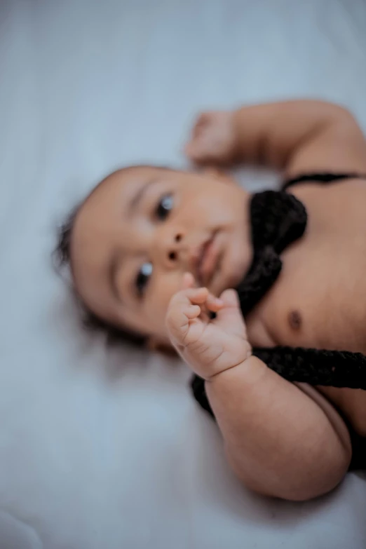 a little baby that is laying down on a bed