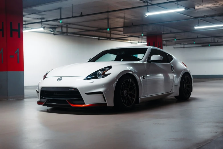 a white sports car sits in the dark