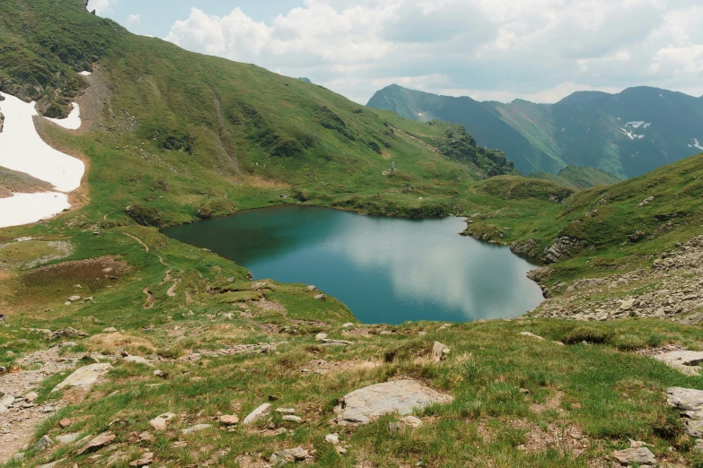 a couple of hills with a large body of water