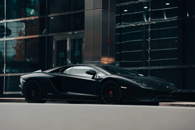 the black sports car is parked on the street