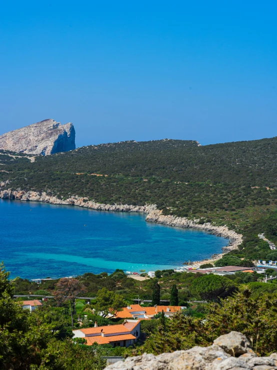 a large body of water with green trees around it