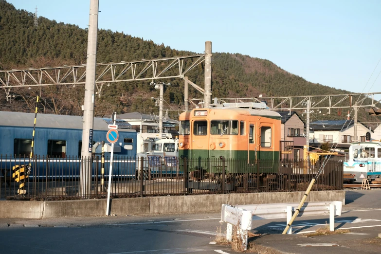 several trains parked on the tracks at the train station